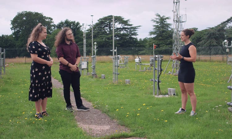 Students interviewing climate expert on roof of Meteorology building