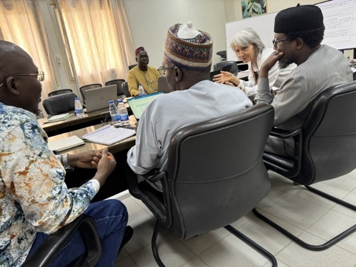 AGRHYMET colleagues and Celia Petty in discussion 